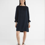 Woman wearing a dark blue dress on a white background