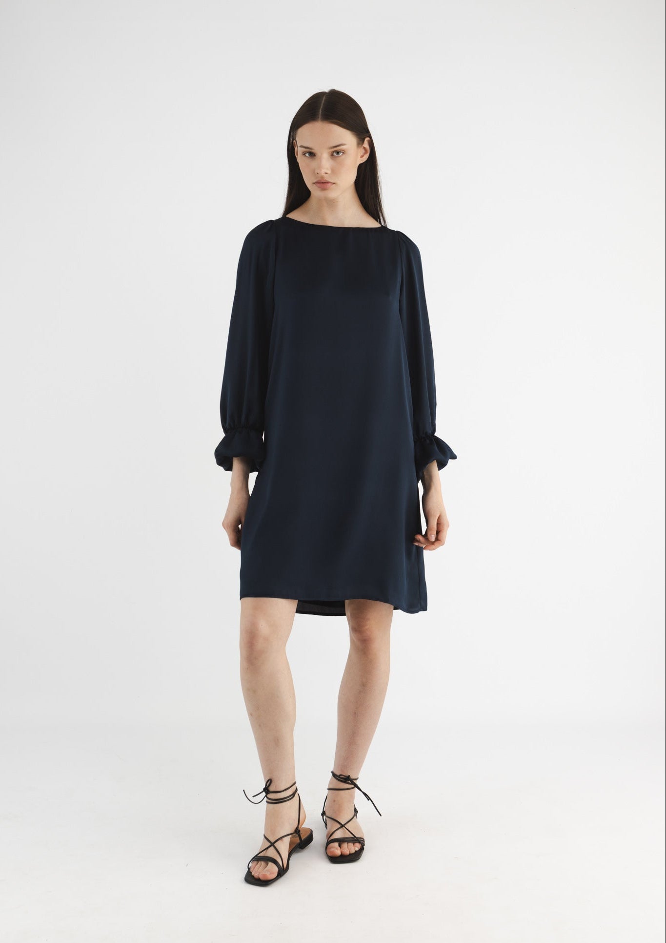 Woman wearing a dark blue dress on a white background