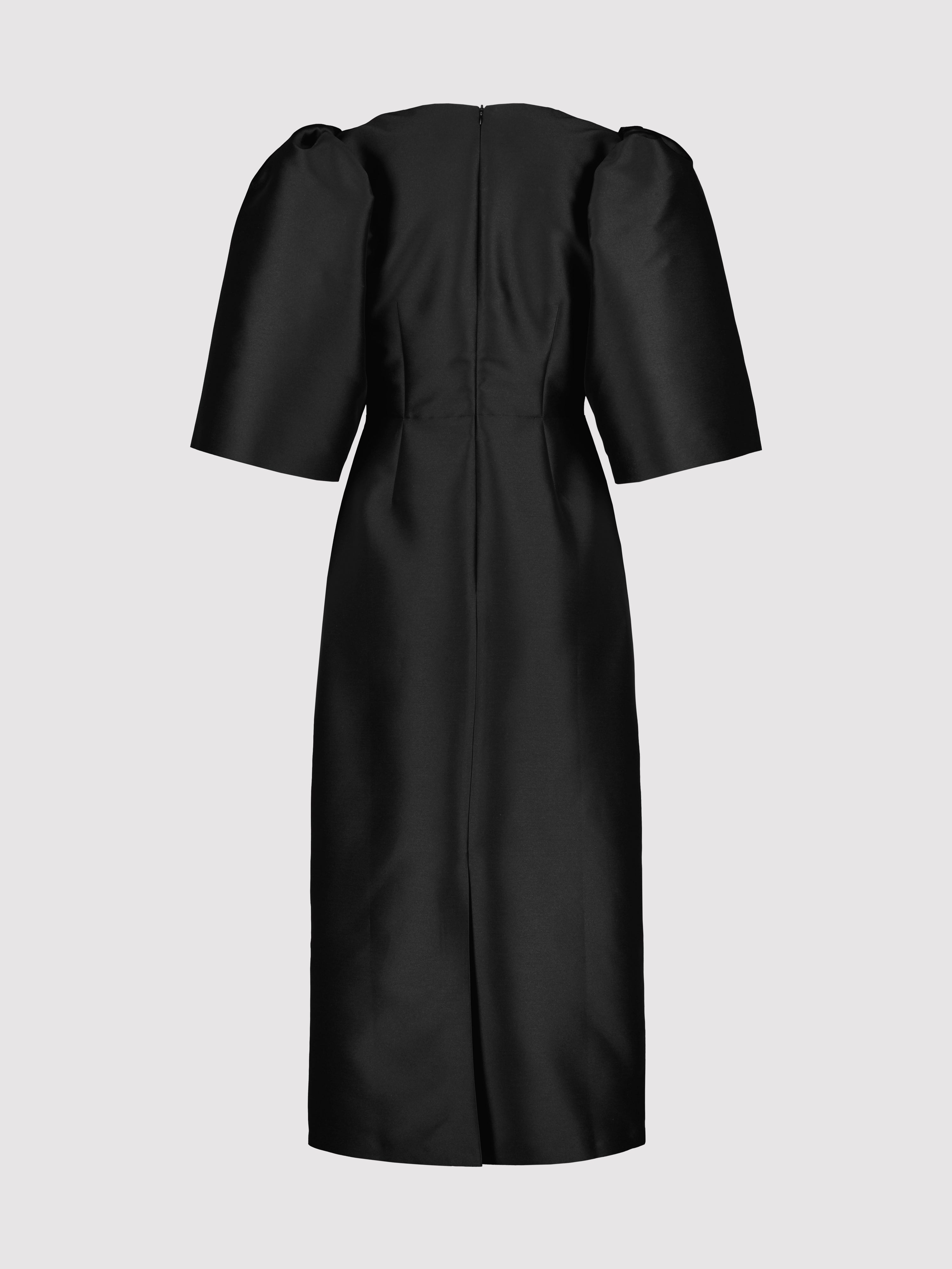 Black dress with puff sleeves on a light gray background