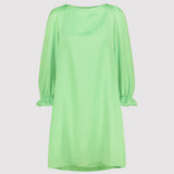 Mint green dress with long sleeves on a light gray background