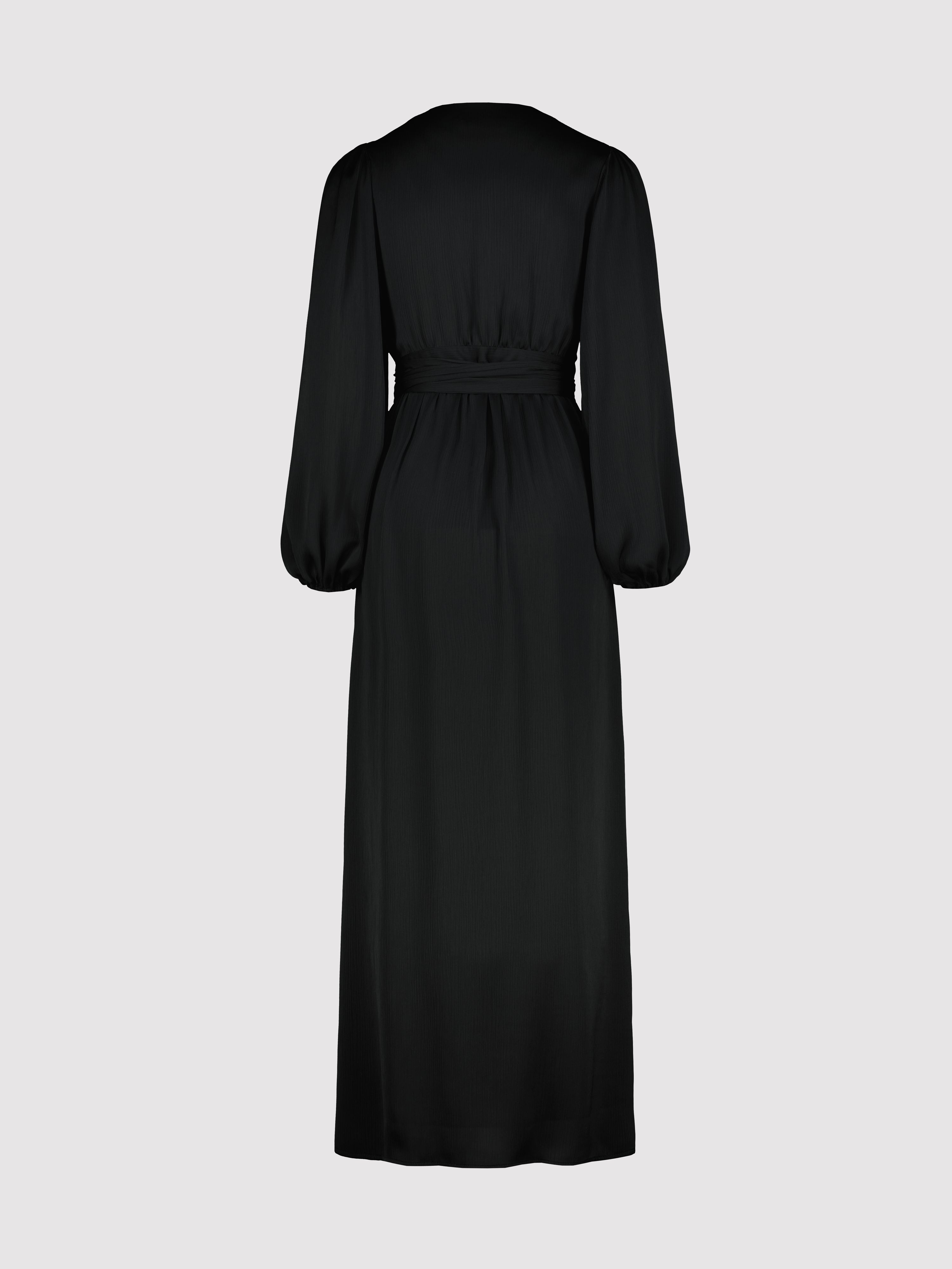 Black dress with long sleeves on a light gray background