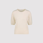 Cream-colored short sleeve sweater on a light gray background