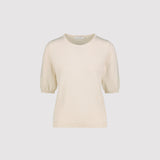 Cream-colored short sleeve sweater on a light gray background