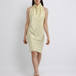 Woman wearing a light yellow dress on a white background