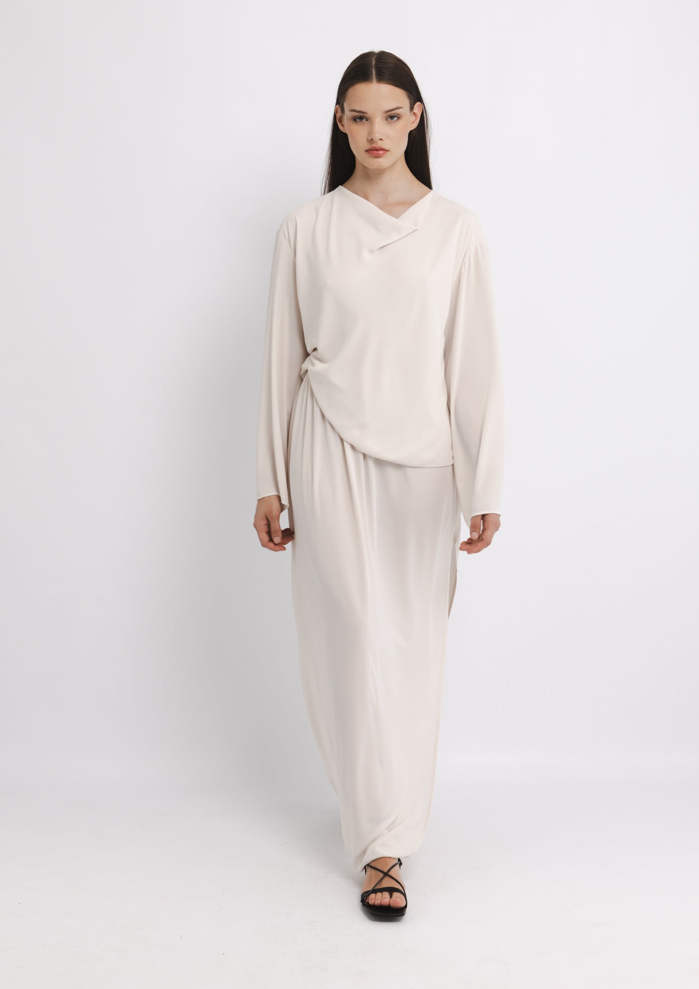 Woman wearing a beige outfit on a white background