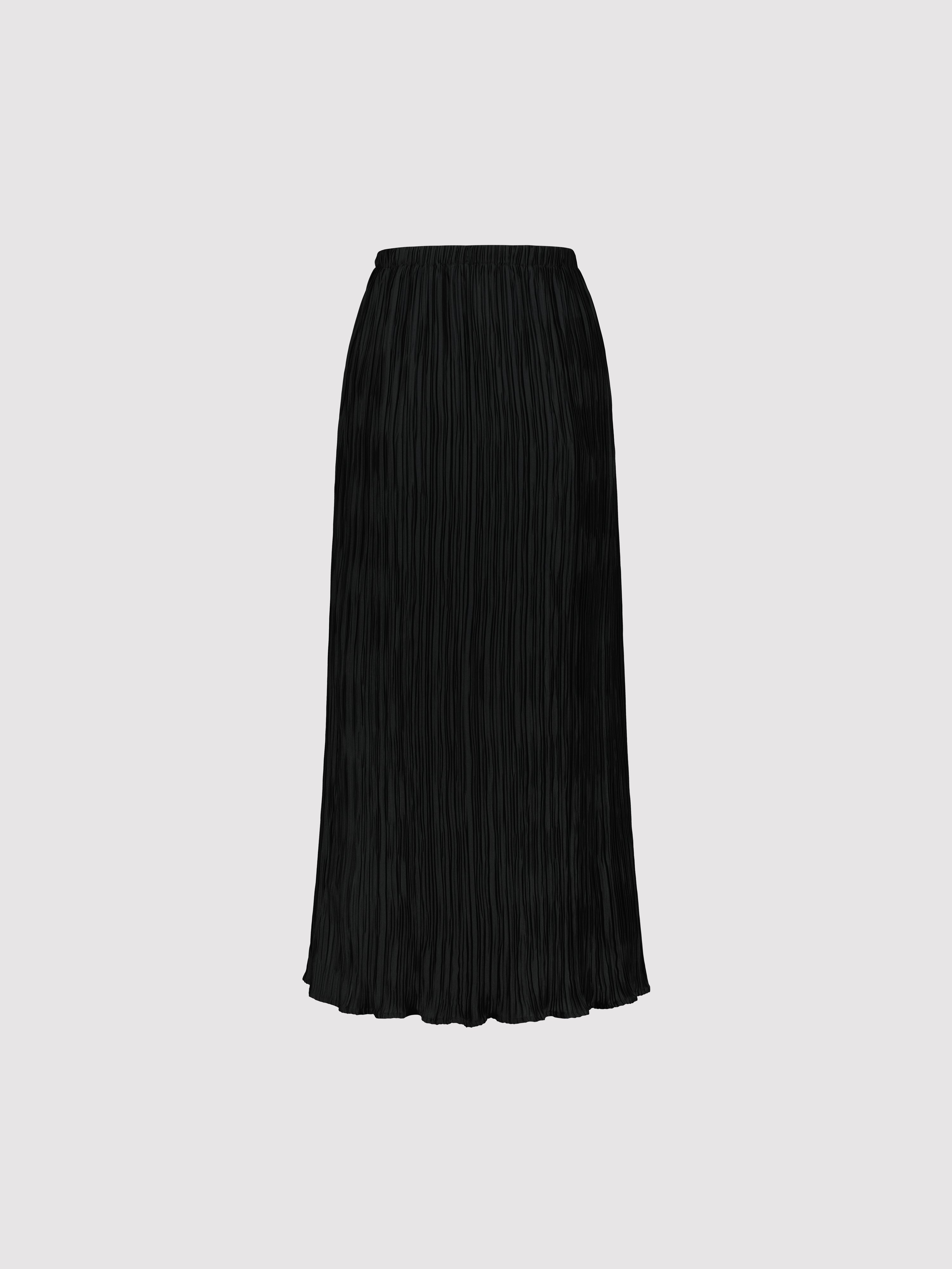 Black pleated skirt on a light gray background