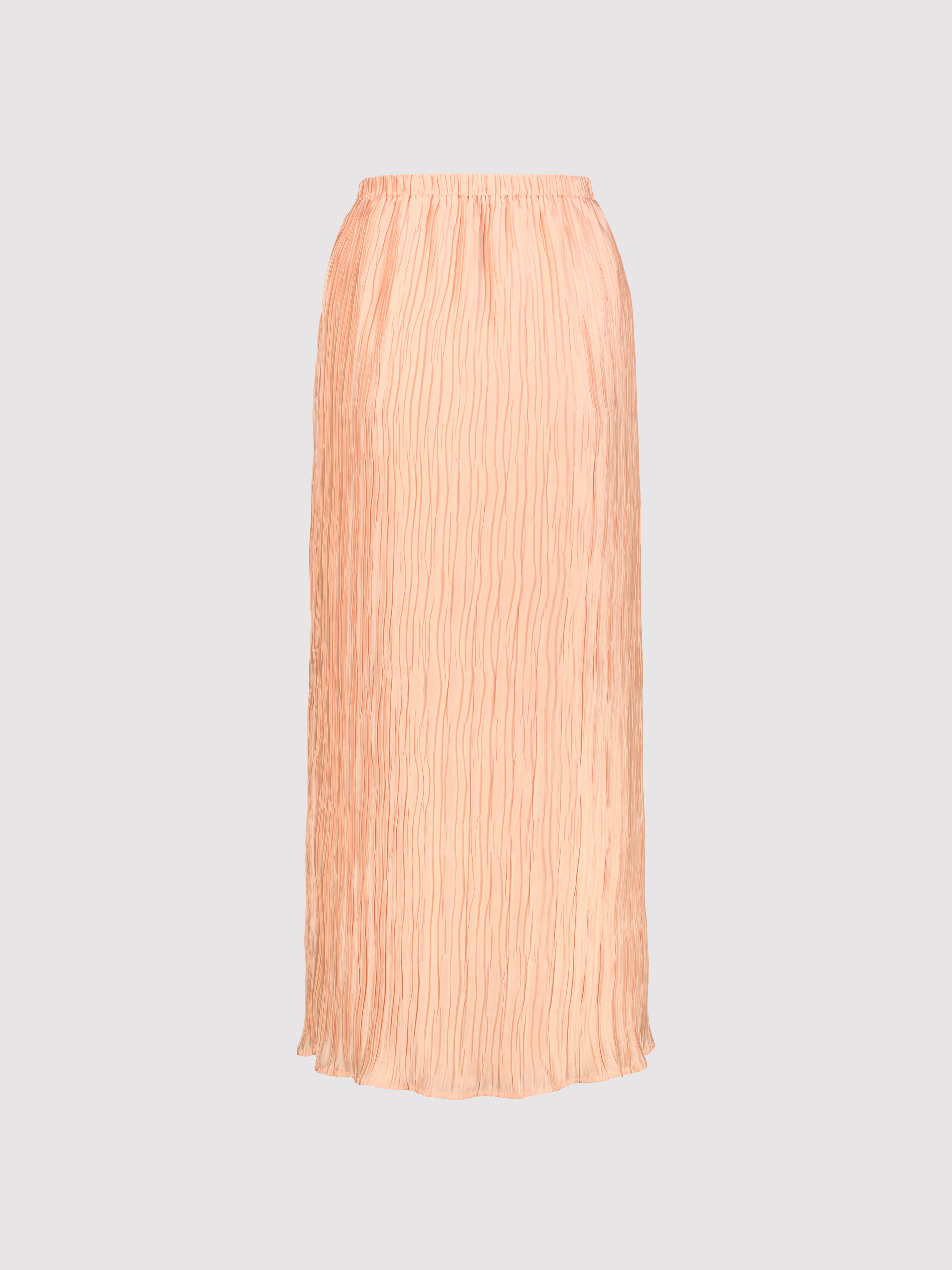 Peach pleated skirt on a light gray background