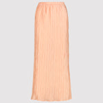 Peachy pleated skirt on a light gray background