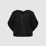 Black pleated blouse on a light gray background