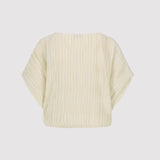 Beige plisse crop top on a light gray background