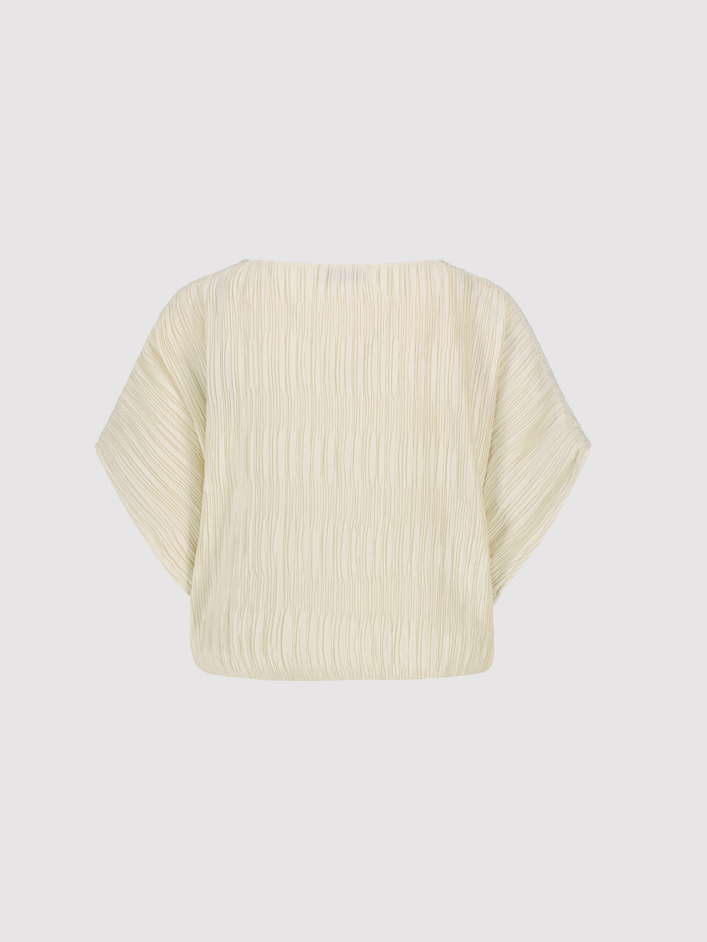 Beige plisse crop top on a light gray background