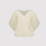 Cream-colored plisse top on a light gray background