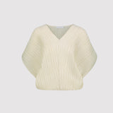 Cream-colored plisse top on a light gray background